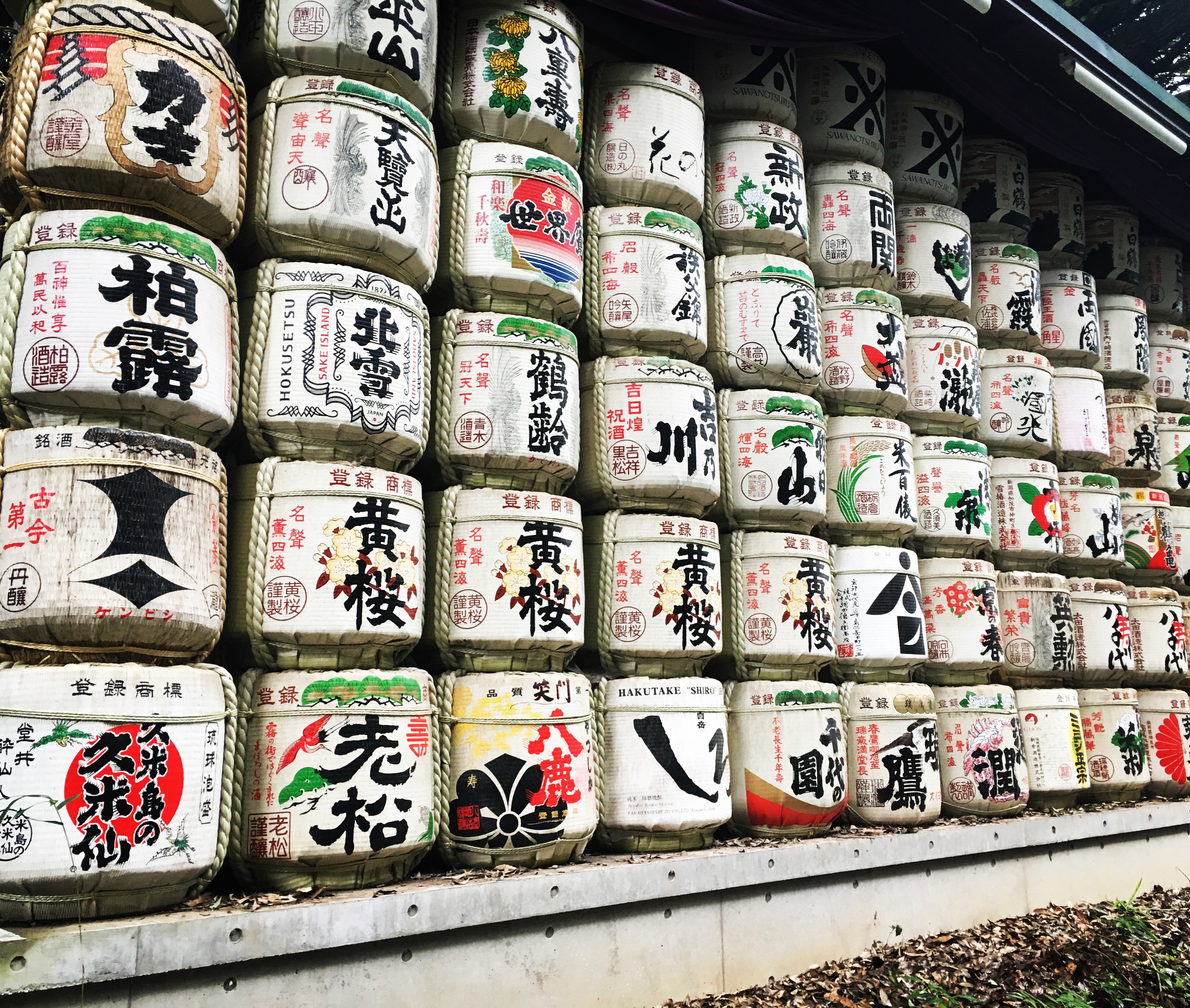 Old sake barrels with Japanese writing piled hire in Tokyo park